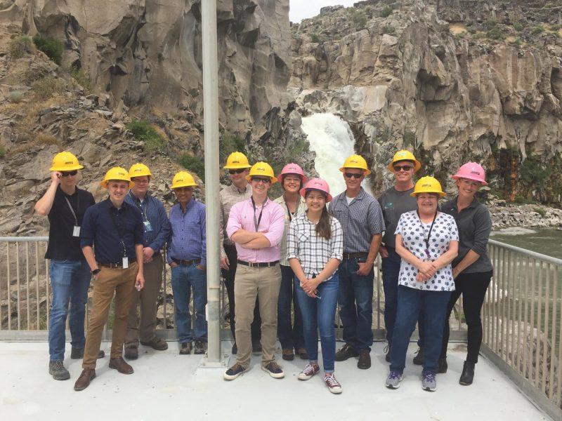 Image of a group of engineering interns at a hydro power facility.